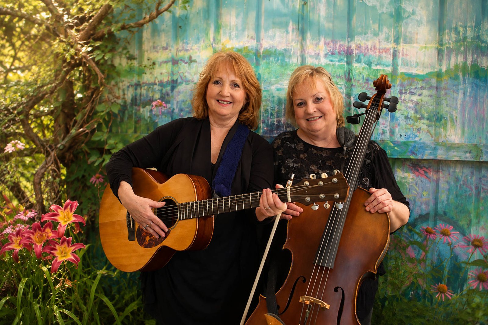 Tish and Laurie playing guitar and cello together